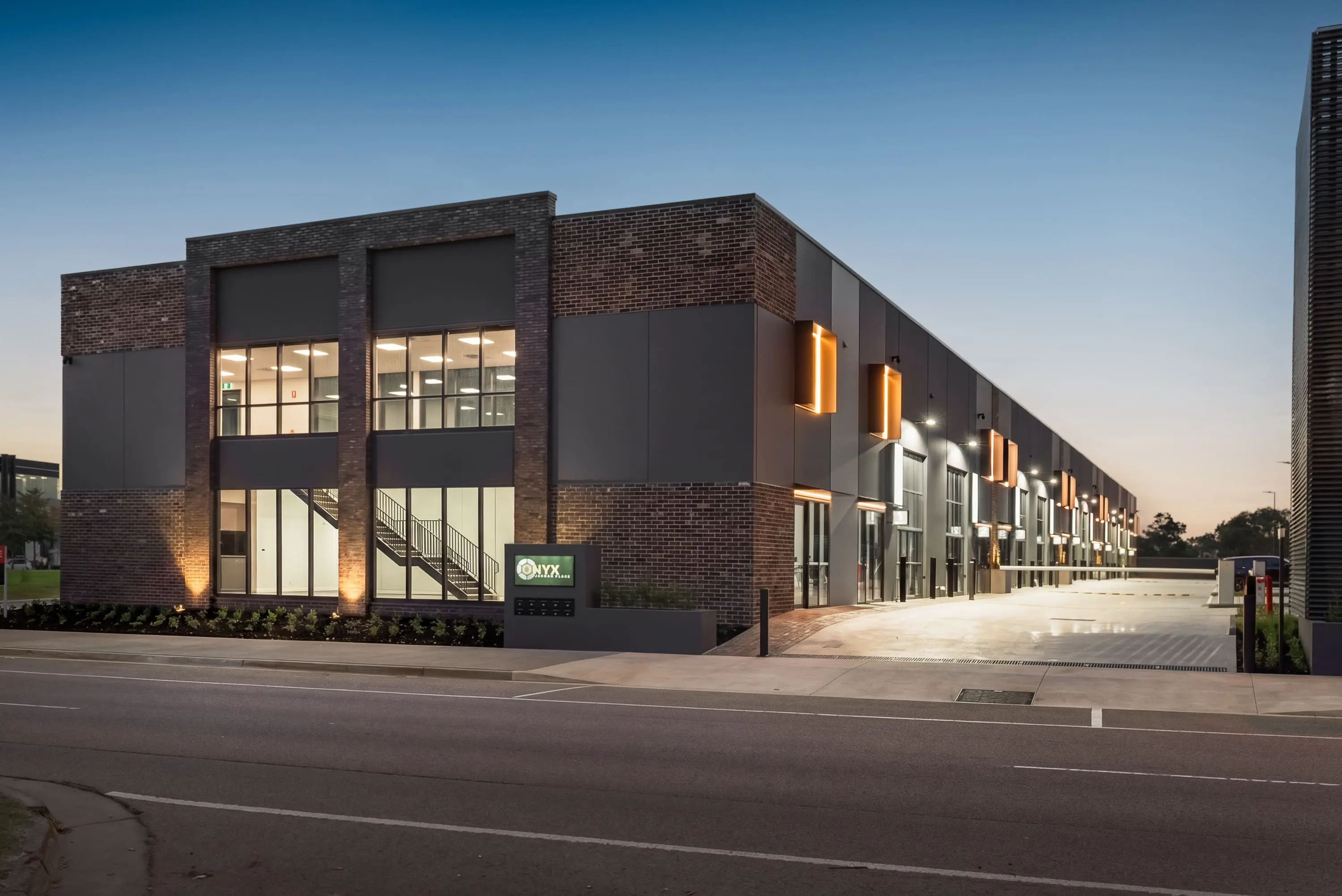 Jacoah Place premium warehouse and showroom façade at dusk, Narre Warren
