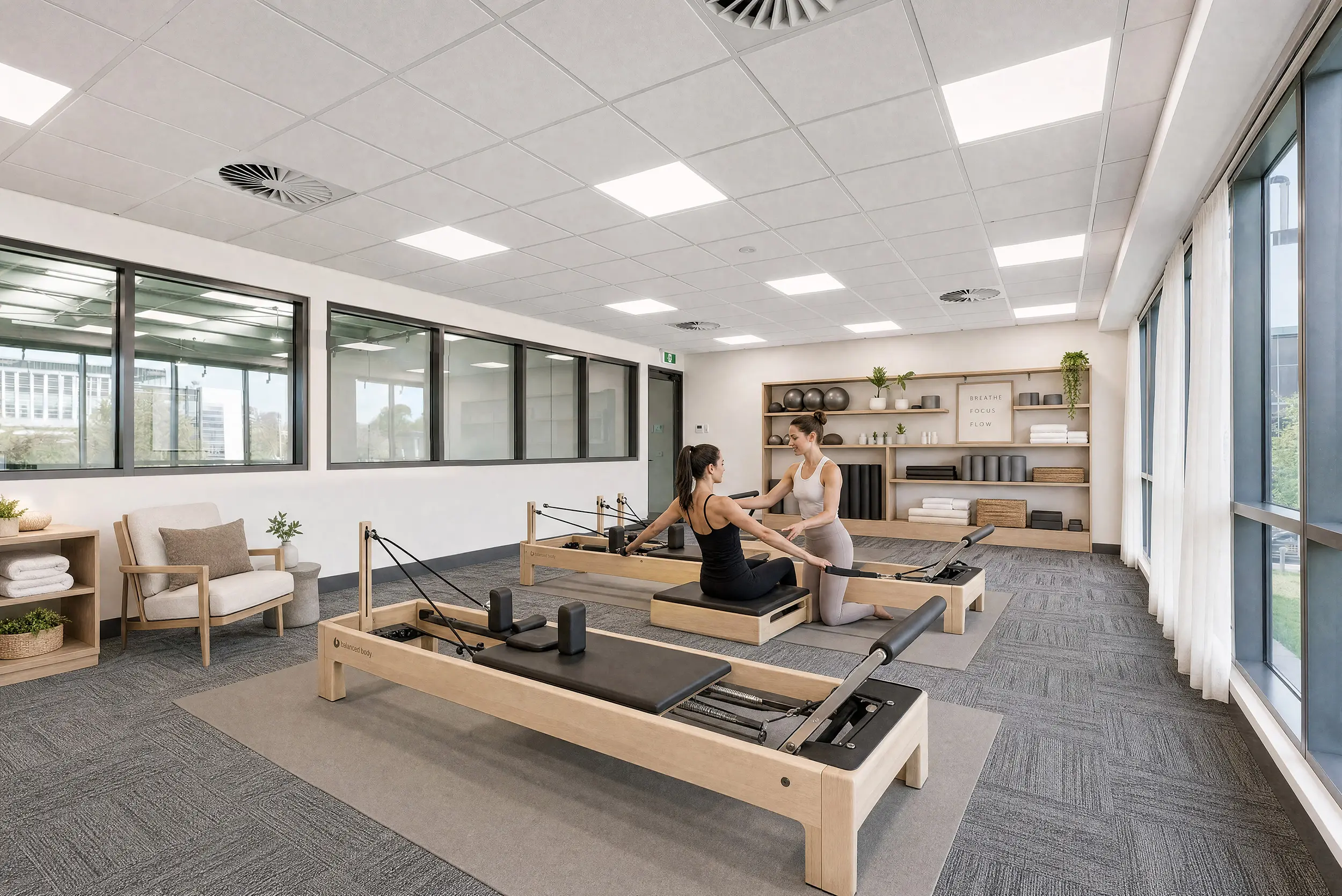 The mezzanine of a Jacoah Place tenancy styled as a pilates studio, with reformer beds, full-height glazing and equipment shelving